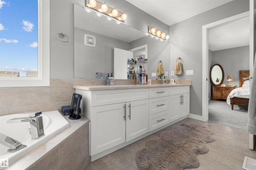 Double vanity with white cabinetry and light-toned countertops - 524 Mcdonough Way, Edmonton, AB - Indoor Photo Showing Bathroom