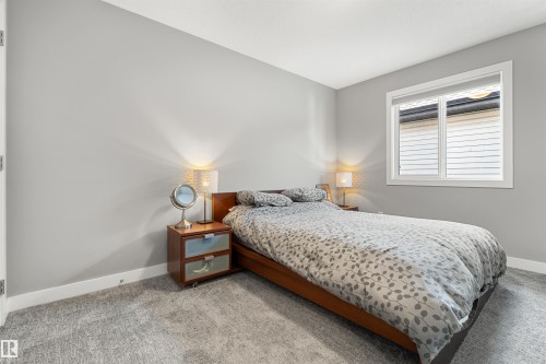 Bedroom featuring neutral gray walls, a single window with white trim, and gray patterned carpeting - 524 Mcdonough Way, Edmonton, AB - Indoor Photo Showing Bedroom