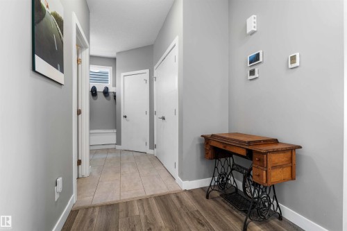 Hallway featuring wood-finish flooring transitioning to tile - 524 Mcdonough Way, Edmonton, AB - Indoor Photo Showing Other Room