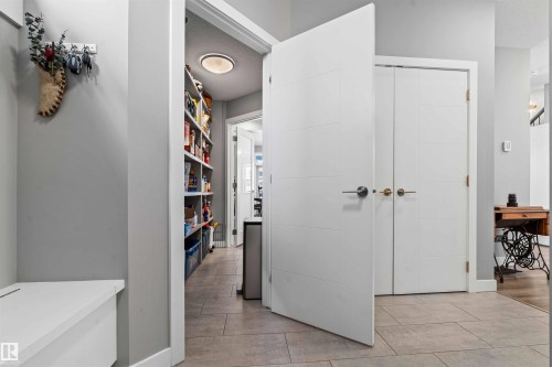 Hallway featuring light gray walls, built-in white bench seating, and tiled flooring - 524 Mcdonough Way, Edmonton, AB - Indoor Photo Showing Other Room