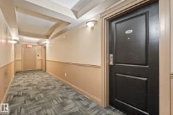 Entry door featuring a panel design and brushed nickel hardware - 