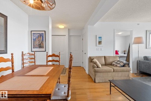 Open-concept living area featuring wood-finish flooring and white walls - 905 10303 105 Street Nw, Edmonton, AB - Indoor Photo Showing Living Room
