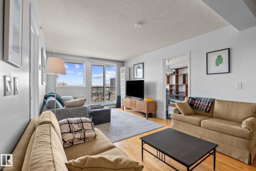 Hardwood-style flooring throughout living area - 905 10303 105 Street Nw, Edmonton, AB - Indoor Photo Showing Living Room