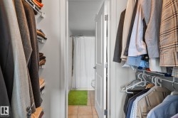 Walk-in closet with white wire shelving and hanging rods - 