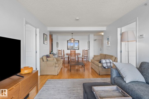 Expansive living area featuring wood-finish flooring, light-colored walls, and recessed lighting - 905 10303 105 Street Nw, Edmonton, AB - Indoor Photo Showing Living Room