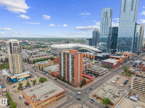 Expansive urban skyline featuring contemporary high-rise buildings and a modern stadium structure - 905 10303 105 Street Nw, Edmonton, AB - Outdoor With View