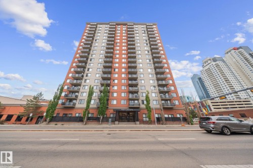 High-rise building featuring a modern facade with alternating terracotta-toned and light grey panels - 905 10303 105 Street Nw, Edmonton, AB - Outdoor With Balcony With Facade