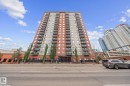 High-rise building featuring a modern facade with alternating terracotta-toned and light grey panels - 905 10303 105 Street Nw, Edmonton, AB  - Outdoor With Balcony With Facade 