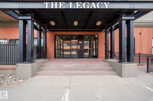 Building entrance featuring a prominent covered portico with black structural columns and "THE LEGACY" signage - 905 10303 105 Street Nw, Edmonton, AB - Outdoor