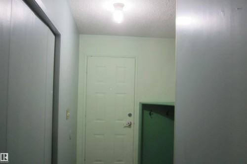 Entryway featuring a paneled door with hardware, a flush-mount ceiling light, and light-toned walls - 3814 37 Avenue, Leduc, AB - Indoor Photo Showing Other Room