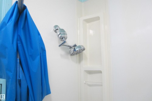 Shower with integrated shelving, chrome fixtures, and a dual-head shower system - 3814 37 Avenue, Leduc, AB - Indoor Photo Showing Other Room
