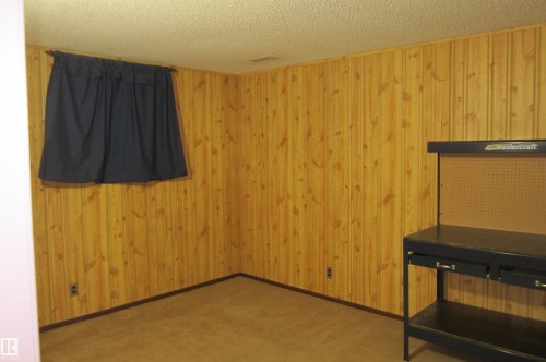 Room with wood-finish paneling and wall-to-wall carpeting - 3814 37 Avenue, Leduc, AB - Indoor Photo Showing Other Room