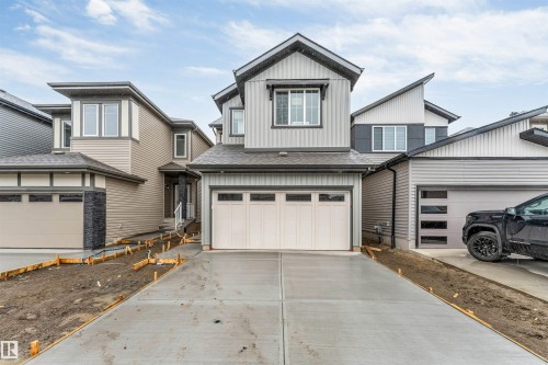 Contemporary two-story residence featuring a two-car garage, concrete driveway, and mixed siding exterior - 1972 210 Street, Edmonton, AB - Outdoor