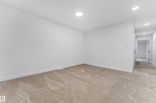 Spacious interior with neutral carpeting, recessed lighting, white walls, and white trim - 1972 210 Street, Edmonton, AB - Indoor Photo Showing Other Room