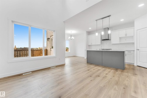 Open-concept living space featuring high ceilings and wood-finish flooring - 1972 210 Street, Edmonton, AB - Indoor Photo Showing Kitchen