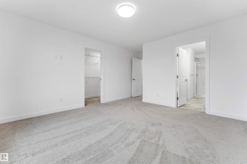 Light gray carpeting, crisp white walls, and a recessed ceiling light create a bright atmosphere - 1972 210 Street, Edmonton, AB - Indoor Photo Showing Other Room