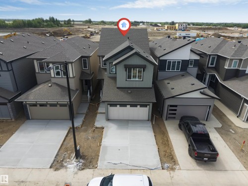 Contemporary two-story home featuring a dual-tone exterior, attached two-car garage, and a concrete driveway - 1972 210 Street, Edmonton, AB - Outdoor With Facade