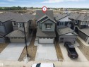 Contemporary two-story home featuring a dual-tone exterior, attached two-car garage, and a concrete driveway - 1972 210 Street, Edmonton, AB  - Outdoor With Facade 