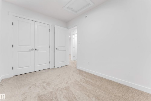 Neutral-toned carpet flooring and white walls - 1972 210 Street, Edmonton, AB - Indoor Photo Showing Other Room