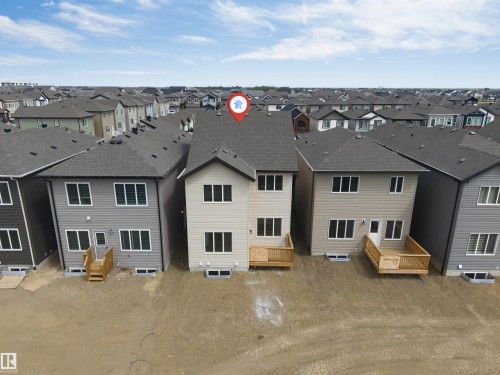Newly constructed two-story residence featuring light-toned siding and a dark shingle roof - 1972 210 Street, Edmonton, AB - Outdoor