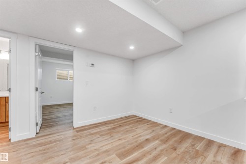 Room featuring wood-finish flooring and recessed ceiling lighting - 1972 210 Street, Edmonton, AB - Indoor Photo Showing Other Room