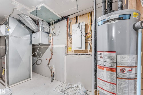 Utility room featuring a water heater, furnace, and exposed electrical wiring - 1972 210 Street, Edmonton, AB - Indoor Photo Showing Basement