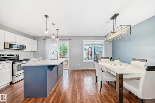 Open-concept kitchen and dining area featuring wood-finish flooring - 17233 88 Street, Edmonton, AB - Indoor