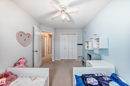 Bedroom featuring light blue and gray walls, a ceiling fan with integrated lighting, and carpeted flooring - 17233 88 Street, Edmonton, AB - Indoor
