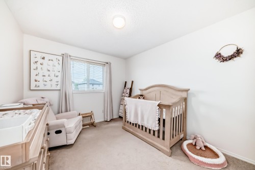 Bright room with a window featuring blinds and light-colored curtains - 17233 88 Street, Edmonton, AB - Indoor Photo Showing Bedroom