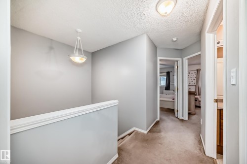 Upper level hallway featuring light gray wall paint and textured ceiling - 17233 88 Street, Edmonton, AB - Indoor Photo Showing Other Room