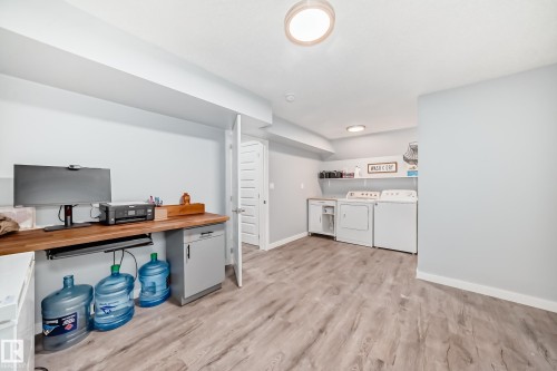 Wood-finish flooring throughout, with a built-in wood countertop desk area - 17233 88 Street, Edmonton, AB - Indoor Photo Showing Office