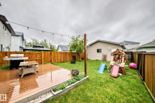Expansive backyard featuring a wood-finish deck, string lighting, and a wood privacy fence - 17233 88 Street, Edmonton, AB - Outdoor With Deck Patio Veranda