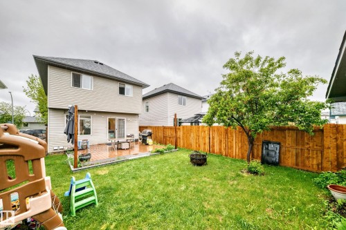 Expansive backyard featuring a manicured lawn, a mature tree, a privacy fence, and a patio area with pavers - 17233 88 Street, Edmonton, AB - Outdoor