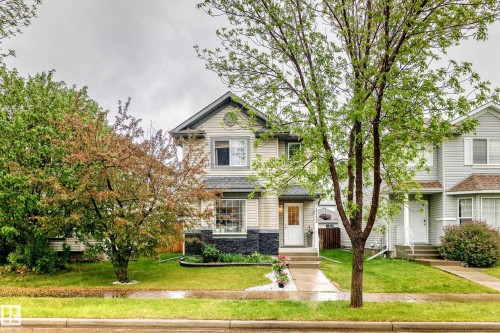 Two-story residence featuring light-colored siding and a dark-toned stone façade accent - 17233 88 Street, Edmonton, AB - Outdoor With Facade
