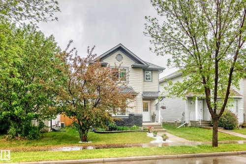 Two-story residence featuring light-colored siding and a dark roof - 17233 88 Street, Edmonton, AB - Outdoor