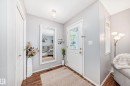 Entryway featuring wood-finish flooring, light grey wall paint, and a built-in closet with a white panel door - 17233 88 Street, Edmonton, AB  - Indoor Photo Showing Other Room 