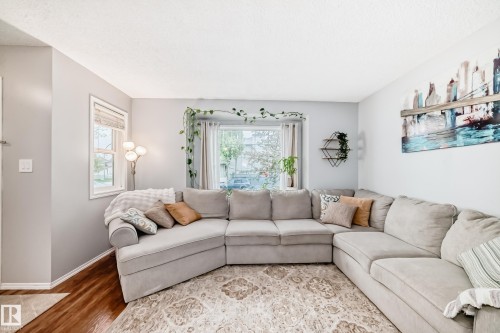 Living area featuring wood-finish flooring and light-toned walls - 17233 88 Street, Edmonton, AB - Indoor Photo Showing Living Room