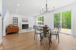 Open-concept living area with wood-finish flooring, a fireplace, and recessed lighting - 