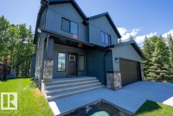 Modern two-story residence featuring a blue vertical and horizontal siding exterior - 