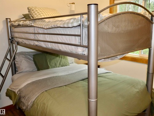 Metal bunk bed frame featuring an integrated ladder and perforated headboards - #20 59316 Rr 54, Rural Barrhead County, AB 