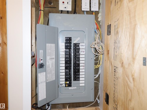 Electrical service panel featuring multiple circuits and exposed wiring - #20 59316 Rr 54, Rural Barrhead County, AB 