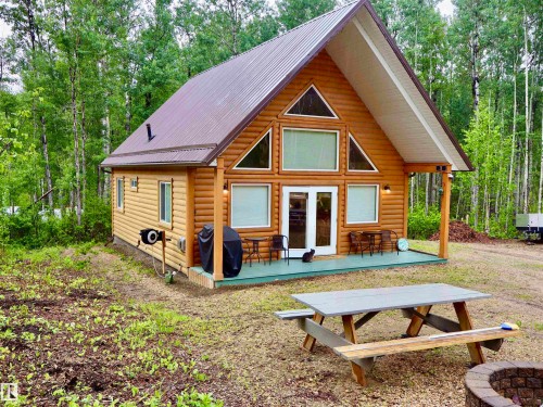 Log-sided cabin featuring a striking A-frame architectural style and a durable metal roof - #20 59316 Rr 54, Rural Barrhead County, AB 