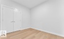 Wood-finish flooring and white walls - 3025 39 Avenue, Beaumont, AB  - Indoor Photo Showing Other Room 