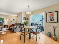 Open-concept living space featuring wood-finish flooring, a sliding glass door, and recessed lighting - 