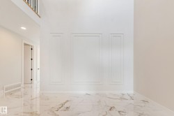 Floor-to-ceiling accent wall featuring decorative molding panels - 