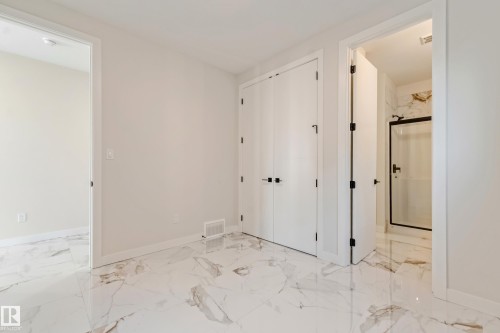 White marble-look flooring throughout featuring subtle veining - 4015 39 Street, Beaumont, AB - Indoor Photo Showing Other Room