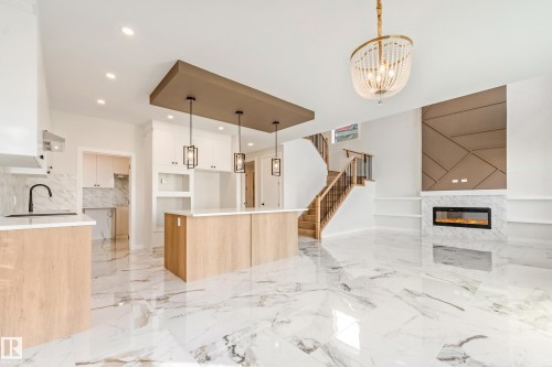 Open-concept interior featuring large format marble-look flooring throughout - 4015 39 Street, Beaumont, AB - Indoor Photo Showing Kitchen