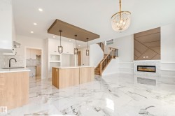 Open-concept interior featuring large format marble-look flooring throughout - 