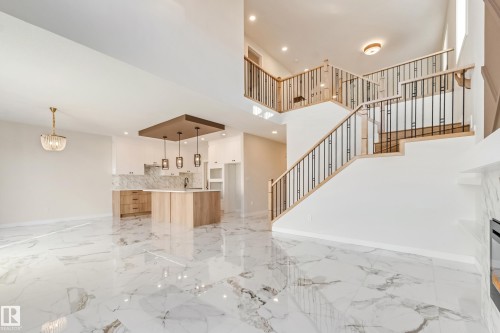 Expansive open-concept space featuring polished marble-look tile flooring - 4015 39 Street, Beaumont, AB - Indoor Photo Showing Other Room