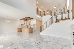 Expansive open-concept space featuring polished marble-look tile flooring - 